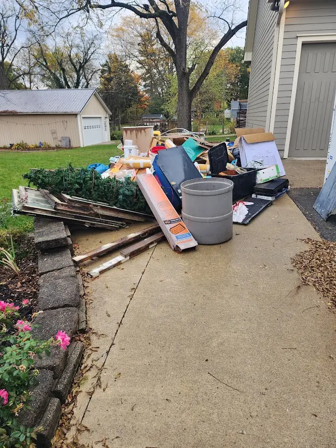 Dumpster being loaded with debris for 10 Yard Dumpster Rental in Derby